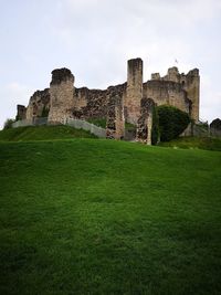 Old ruins on field against sky