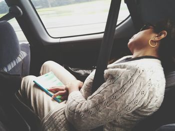 Close-up of woman sleeping in moving car