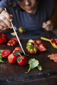 Woman arranging tomatoes for photo