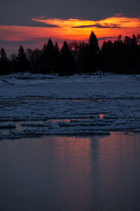 Scenic view of frozen lake against romantic sky at sunset