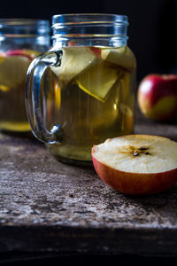 Close-up of apple in jar on table