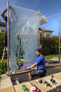 Germany, glaziers attaching glass pane