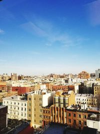 High angle view of cityscape against blue sky