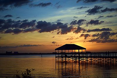 Pier on sea at sunset