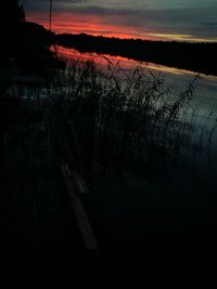 Scenic view of lake against sky at sunset