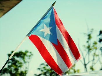 Low angle view of flag against sky