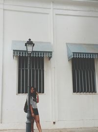 Woman standing against building