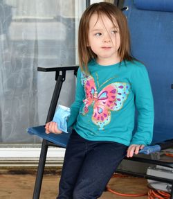 Cute girl sitting on blue chair