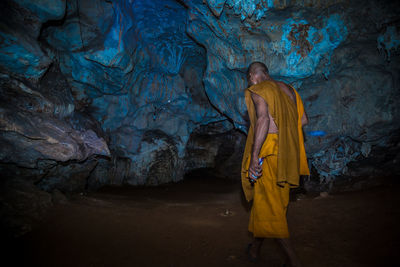 Monk walking in cave