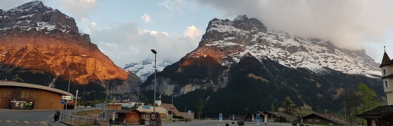Panoramic view of buildings and mountains against sky