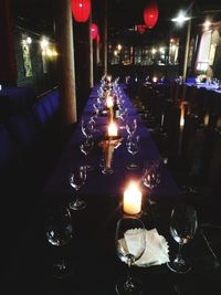 Illuminated tea light candles on table in restaurant
