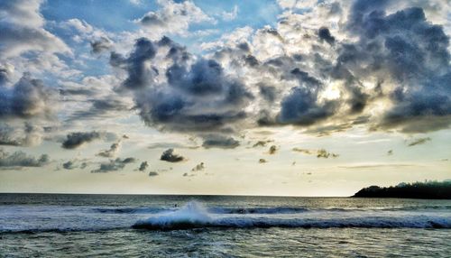 Scenic view of sea against cloudy sky