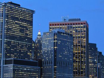 Modern buildings against blue sky at dusk