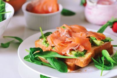 Close-up of salmon sandwich served on table