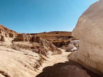 Rock formations on mountain against clear sky