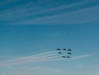 Low angle view of airplane flying against sky