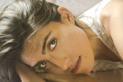 Close-up portrait of young woman at home