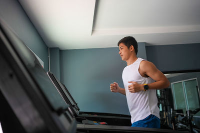 Side view of young man working at home