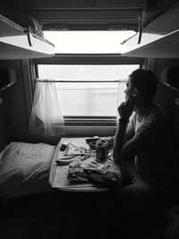 Man sitting on table at home