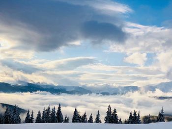 Panoramic view of snow covered landscape against sky