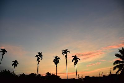 Low angle view of silhouette palm trees against sky during sunset