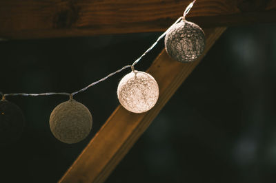 Low angle view of wineglass hanging on wood