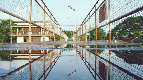 Bridge over canal amidst buildings against clear sky