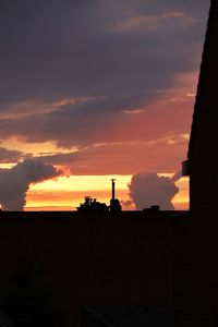 Low angle view of silhouette building against sky during sunset