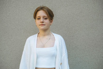 Young girls red hair, cropped short, complements lively eyes in a portrait