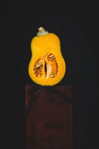 Close-up of yellow fruit against black background