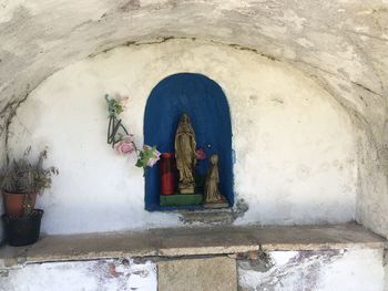Statue against wall of building