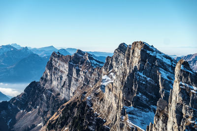 Scenic view of snowcapped mountains against clear sky