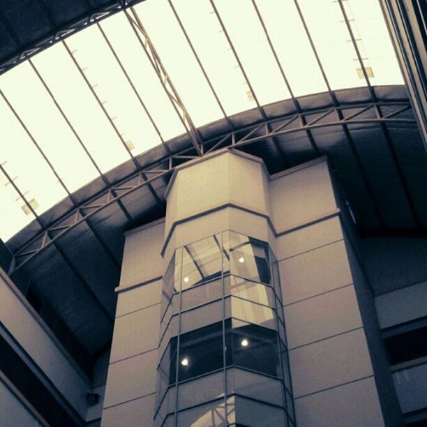 architecture, built structure, low angle view, modern, building exterior, glass - material, window, indoors, office building, building, reflection, city, architectural feature, sky, transparent, skyscraper, glass, no people, day, skylight