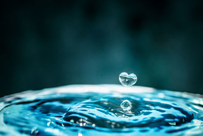 Close-up of rippled water against black background