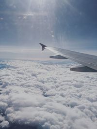 Airplane flying over cloudscape against sky