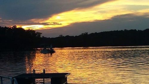 Boats in lake at sunset