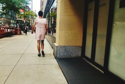 Rear view of woman walking on corridor