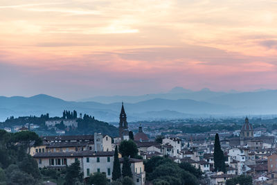 View of buildings in city at sunset