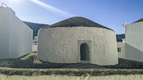 Greece, lindos - june 17, 2021. round white house with arch door, close-up side view.