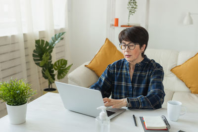 Young woman using laptop at home