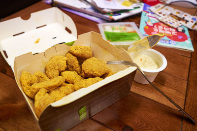 High angle view of fried chickens in box on table