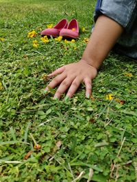 Midsection of child on grassy field