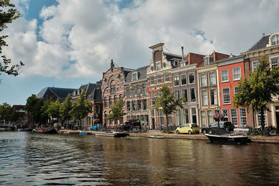 Panoramic view of river amidst buildings against sky