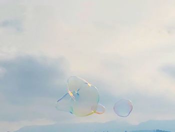 Low angle view of bubbles against sky