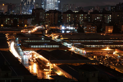 High angle view of illuminated buildings in city at night