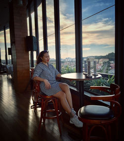 Woman sitting on chair in cafe