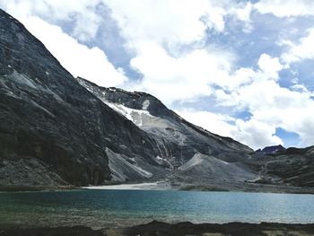 Scenic view of sea and mountains against sky