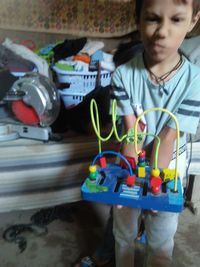 Portrait of boy playing with toy toys