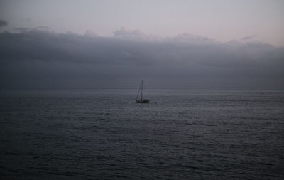 Sailboat sailing on sea against sky