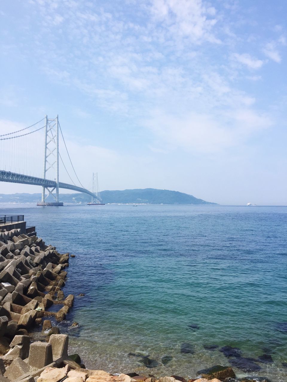 water, sea, sky, rock - object, tranquility, tranquil scene, built structure, nature, scenics, cloud - sky, day, stone - object, beauty in nature, cloud, architecture, river, rippled, outdoors, connection, blue